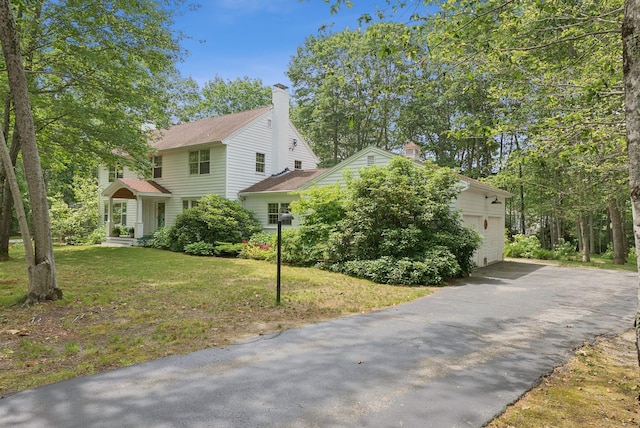 6 Beechwood Ln, Falmouth, ME 04105 - view of front of property featuring asphalt driveway, a chimney, and a front yard