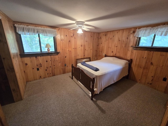 83 Milts Way, Lincoln, ME 04457 - bedroom with wood walls, carpet flooring, and a ceiling fan