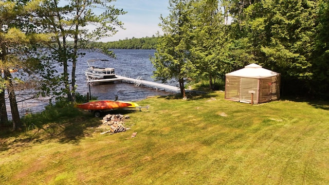 52 Ludden Ln, Lincoln, ME 04457 - view of green lawn with a water view, a boat dock, and a forest view