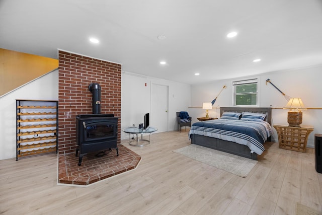 52 Ludden Ln, Lincoln, ME 04457 - bedroom featuring a wood stove, wood finished floors, and recessed lighting