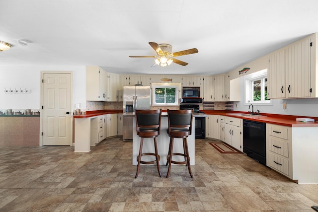 52 Ludden Ln, Lincoln, ME 04457 - kitchen featuring black appliances, cream cabinets, stone finish floors, and a ceiling fan