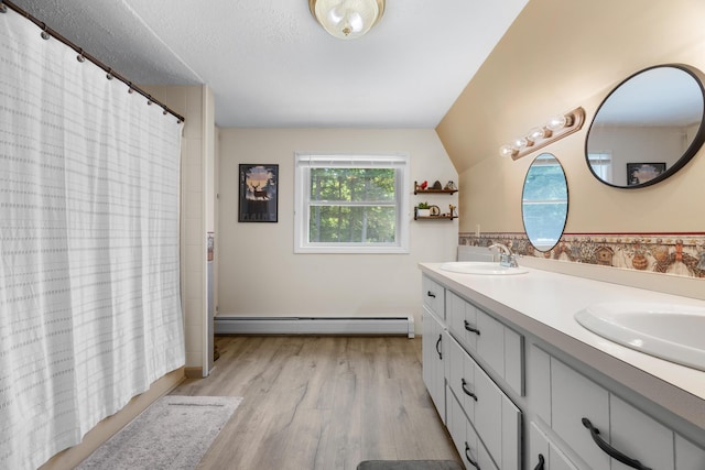 52 Ludden Ln, Lincoln, ME 04457 - bathroom with a baseboard radiator, double vanity, and wood finished floors