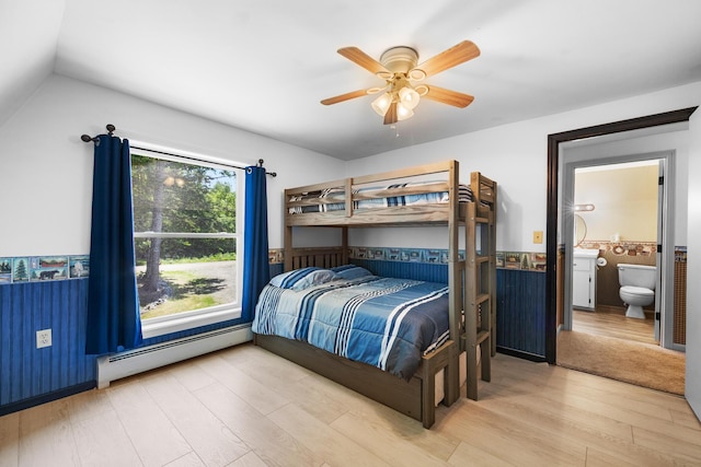 52 Ludden Ln, Lincoln, ME 04457 - bedroom featuring a baseboard heating unit, wood finished floors, wainscoting, ensuite bath, and a ceiling fan