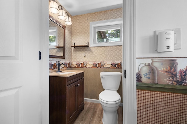 52 Ludden Ln, Lincoln, ME 04457 - bathroom featuring wallpapered walls, vanity, and wood finished floors