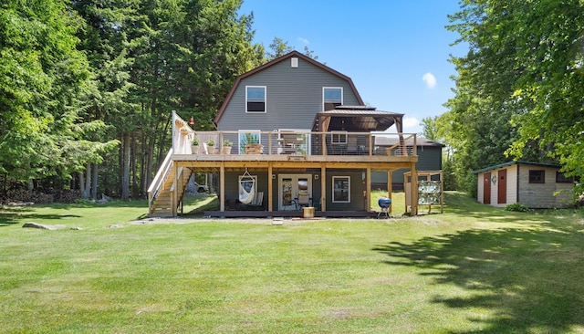 52 Ludden Ln, Lincoln, ME 04457 - back of property with a gambrel roof, a deck, a yard, and a shed