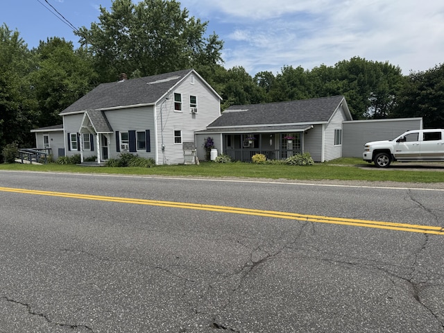 27 Main St, Vassalboro, ME 04989 - view of front facade featuring a shingled roof, a front lawn, and covered porch