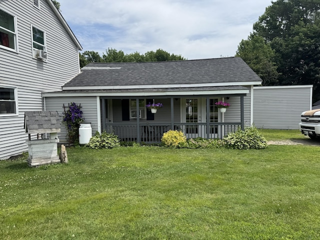 27 Main St, Vassalboro, ME 04989 - view of front facade featuring covered porch, a front lawn, roof with shingles, and cooling unit