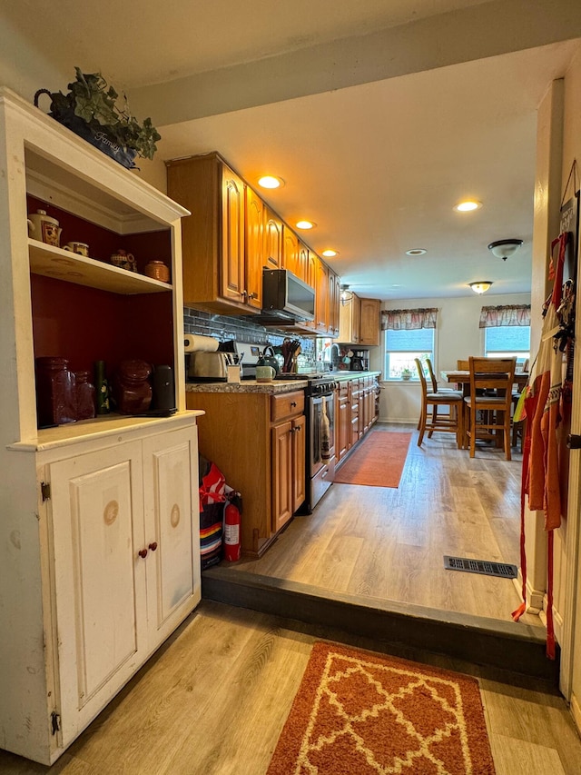 27 Main St, Vassalboro, ME 04989 - kitchen with appliances with stainless steel finishes, brown cabinetry, light wood-type flooring, recessed lighting, and backsplash