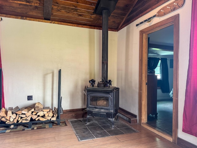 27 Main St, Vassalboro, ME 04989 - detailed view of a wood stove, a wooden ceiling with exposed beams, and wood finished floors