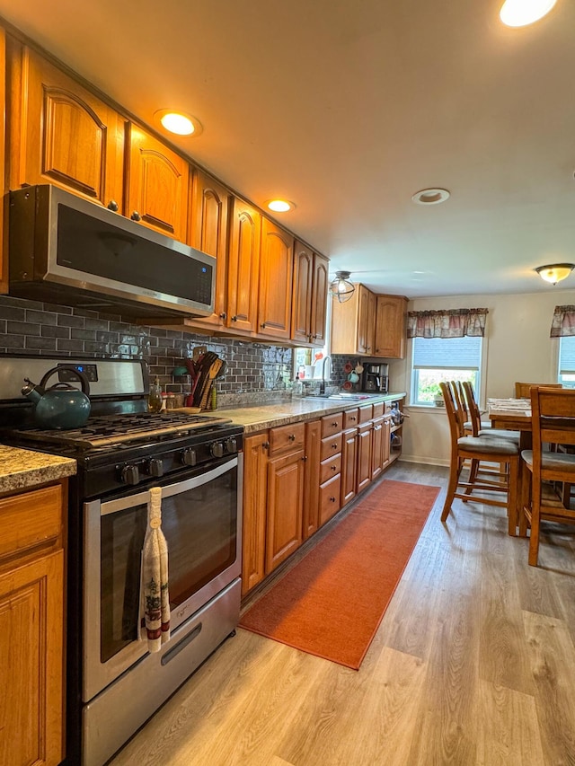 27 Main St, Vassalboro, ME 04989 - kitchen featuring appliances with stainless steel finishes, brown cabinetry, light wood finished floors, and recessed lighting