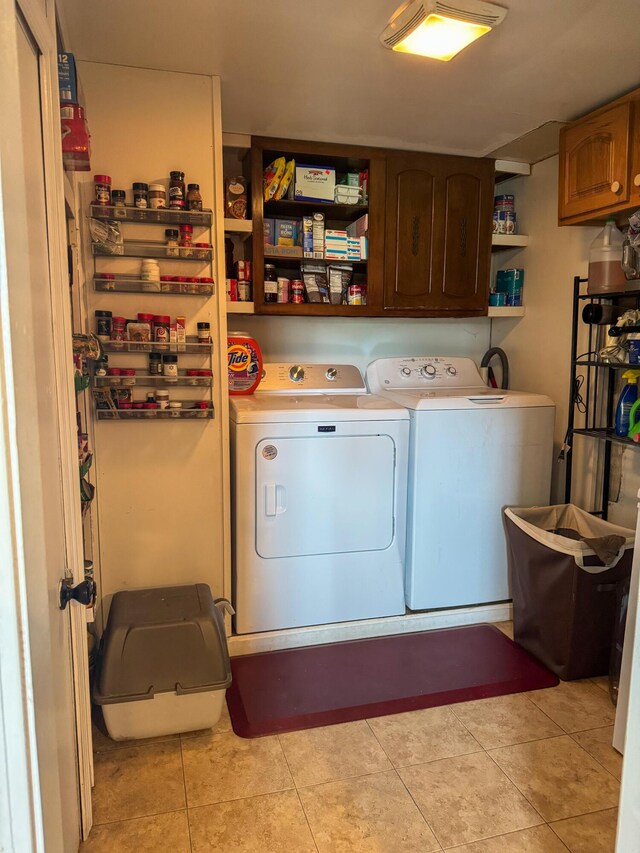 27 Main St, Vassalboro, ME 04989 - washroom featuring cabinet space, washer and clothes dryer, and light tile patterned floors