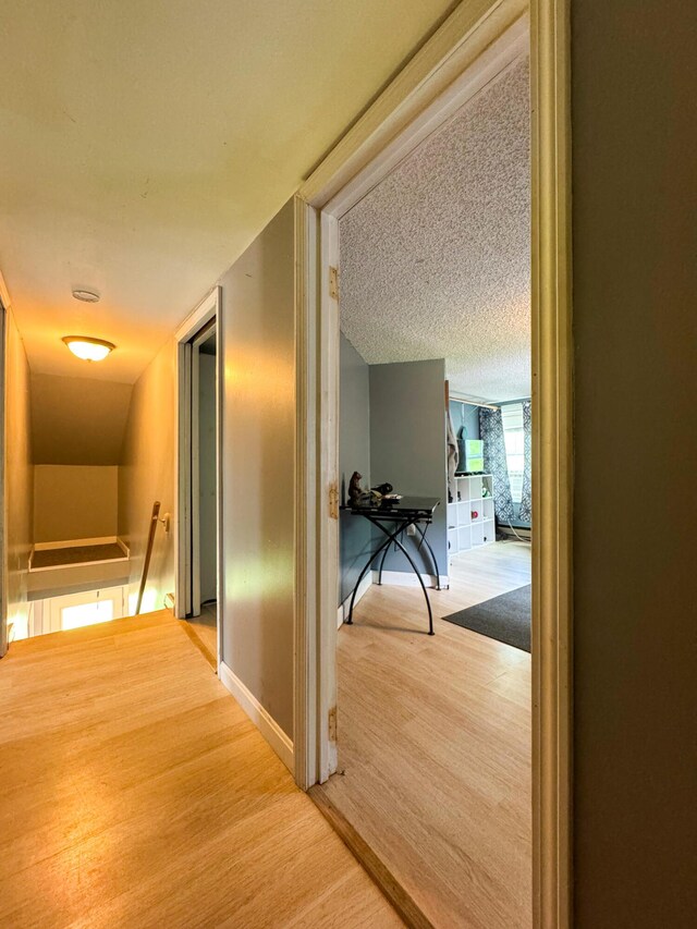 27 Main St, Vassalboro, ME 04989 - corridor with an upstairs landing, wood finished floors, and a textured ceiling