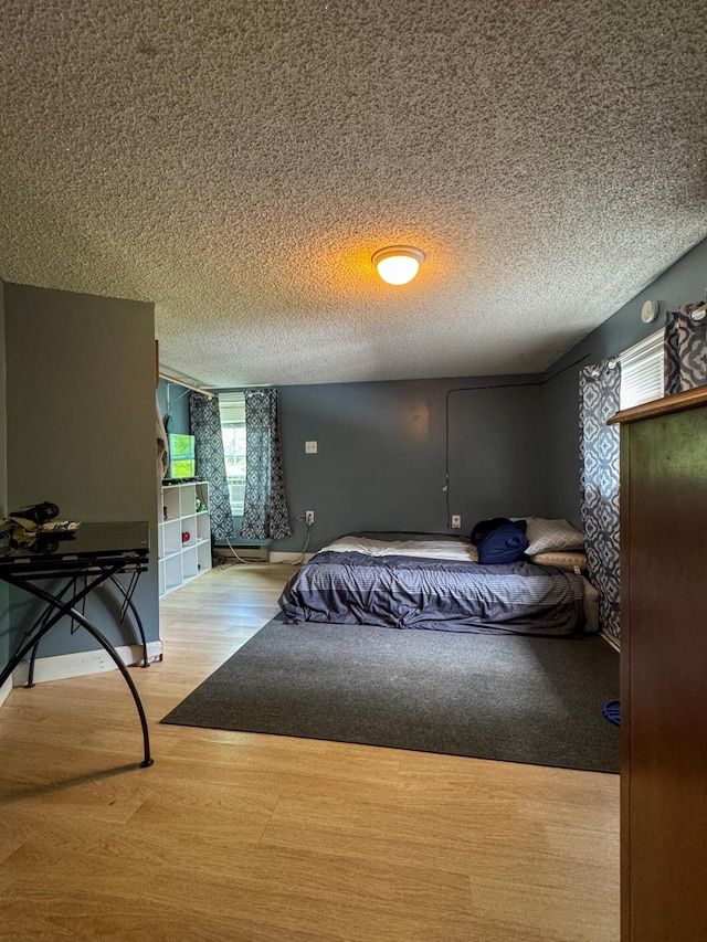 27 Main St, Vassalboro, ME 04989 - bedroom with wood finished floors and a textured ceiling