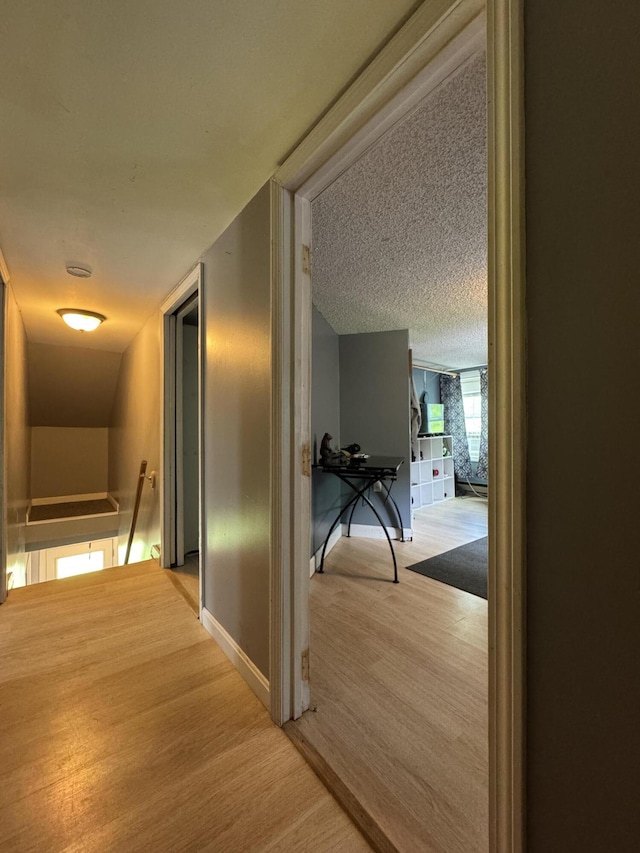 27 Main St, Vassalboro, ME 04989 - hallway with an upstairs landing, light wood-type flooring, and a textured ceiling