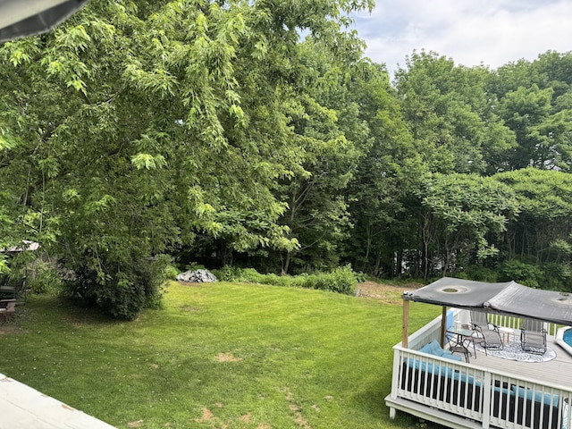 27 Main St, Vassalboro, ME 04989 - view of green lawn with a deck and a wooded view
