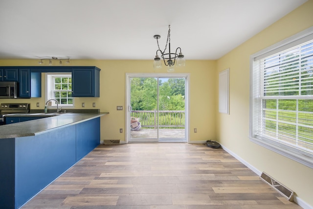 32 Barton Rd, Windsor, ME 04363 - kitchen with stainless steel appliances, blue cabinetry, a chandelier, and light wood-type flooring