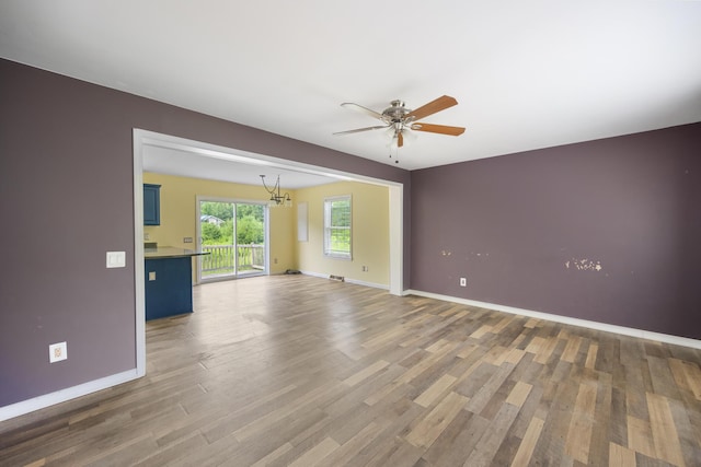 32 Barton Rd, Windsor, ME 04363 - empty room with a chandelier, a ceiling fan, and wood finished floors
