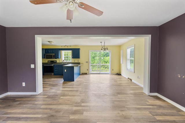 32 Barton Rd, Windsor, ME 04363 - unfurnished living room with wood finished floors, a ceiling fan, and a chandelier