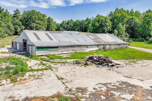 672 Brooks Rd, Knox, ME 04986 - view of front of home with a pole building, an outbuilding, a metal roof, and a detached garage