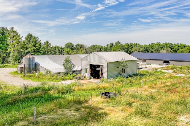 672 Brooks Rd, Knox, ME 04986 - view of front of home with an outbuilding, a garage, and a metal roof