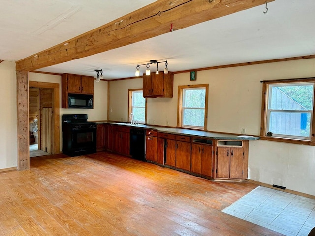 5 Abagail Rock Rd, Vinalhaven, ME 04863 - kitchen with black appliances, light wood-style flooring, brown cabinets, and beamed ceiling