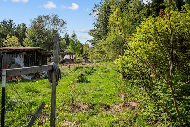 138 Main St, Brownfield, ME 04010 - view of yard featuring a forest view, an outdoor structure, and a pole building