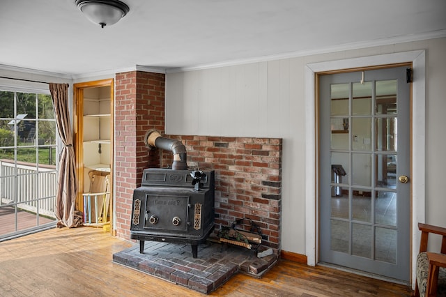 138 Main St, Brownfield, ME 04010 - detailed view of a wood stove, crown molding, and wood finished floors