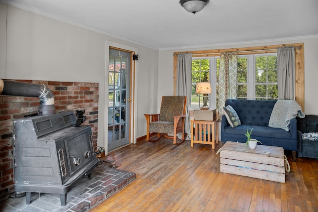 138 Main St, Brownfield, ME 04010 - living room with a wood stove, healthy amount of natural light, crown molding, and wood-type flooring