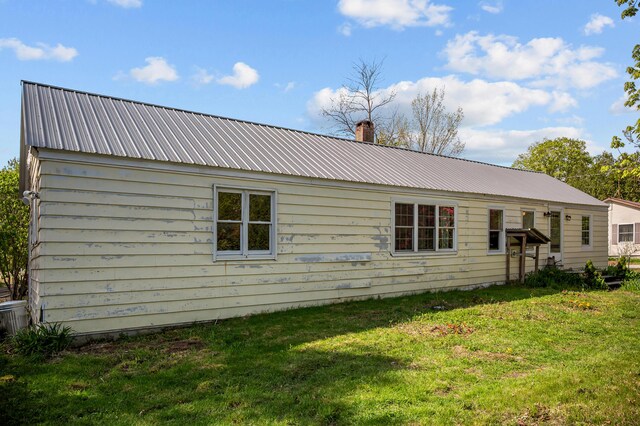 138 Main St, Brownfield, ME 04010 - rear view of property with a metal roof, a lawn, and a chimney