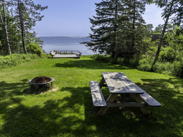 585 N Lubec Rd, Lubec, ME 04652 - view of grassy yard featuring a fire pit and a deck with water view