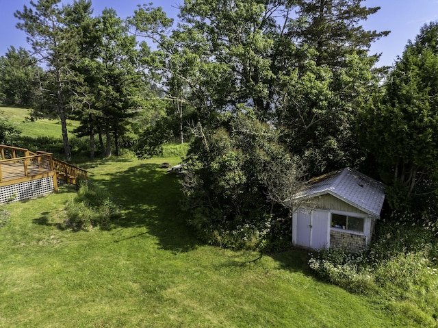 585 N Lubec Rd, Lubec, ME 04652 - view of green lawn with a deck and a shed