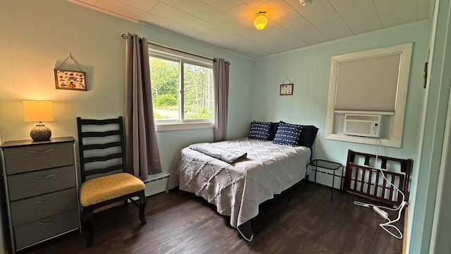 585 N Lubec Rd, Lubec, ME 04652 - bedroom featuring ornamental molding, dark wood finished floors, a baseboard radiator, and cooling unit
