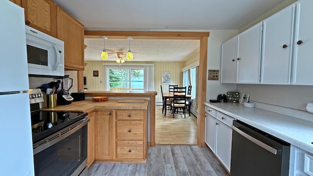 585 N Lubec Rd, Lubec, ME 04652 - kitchen with white appliances, light wood-style floors, a peninsula, decorative light fixtures, and baseboard heating