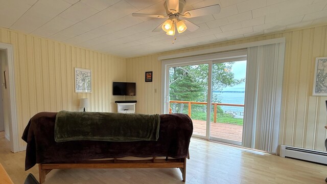 585 N Lubec Rd, Lubec, ME 04652 - living room featuring baseboard heating, wood finished floors, and ceiling fan