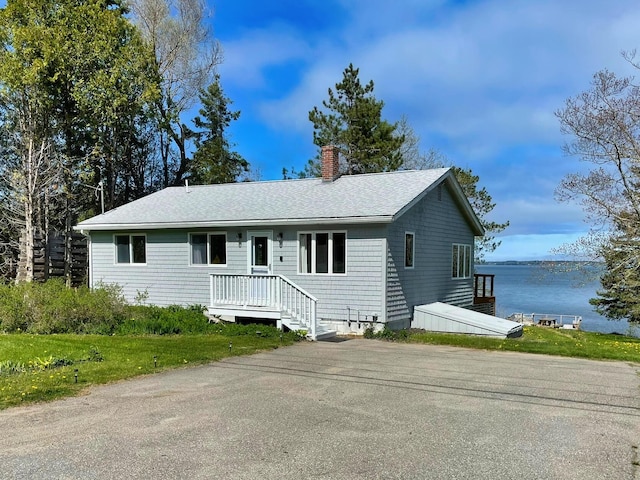 585 N Lubec Rd, Lubec, ME 04652 - single story home with a chimney, roof with shingles, and a water view