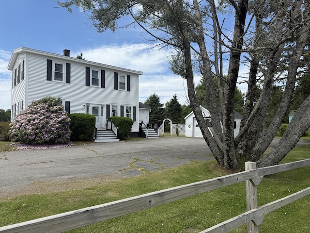 269 County Rd, Lubec, ME 04652 - colonial inspired home with a chimney, an outbuilding, and driveway