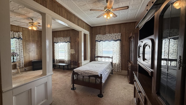 269 County Rd, Lubec, ME 04652 - bedroom with wood walls, light carpet, an ornate ceiling, ceiling fan, and crown molding