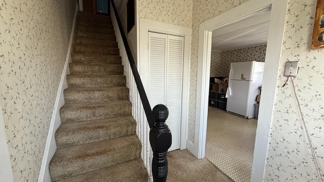 269 County Rd, Lubec, ME 04652 - stairway with wallpapered walls and carpet flooring
