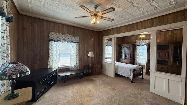 269 County Rd, Lubec, ME 04652 - bedroom with an ornate ceiling, wooden walls, multiple windows, light colored carpet, and ceiling fan