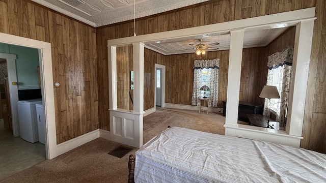 269 County Rd, Lubec, ME 04652 - carpeted bedroom featuring wooden walls, washer / dryer, an ornate ceiling, and crown molding