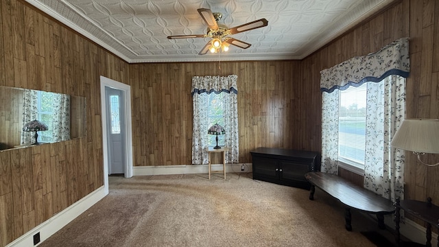 269 County Rd, Lubec, ME 04652 - living area featuring an ornate ceiling, wood walls, healthy amount of natural light, carpet, and ceiling fan
