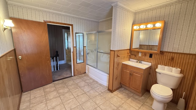 269 County Rd, Lubec, ME 04652 - full bathroom with wainscoting, vanity, wallpapered walls, shower / bath combination with glass door, and ornamental molding