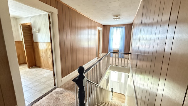 269 County Rd, Lubec, ME 04652 - hallway featuring an upstairs landing, wooden walls, and crown molding