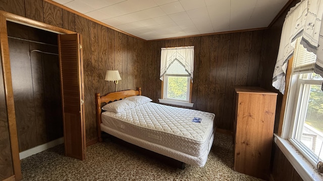 269 County Rd, Lubec, ME 04652 - carpeted bedroom with wood walls and a closet