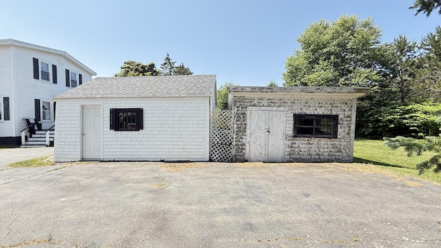 269 County Rd, Lubec, ME 04652 - view of front of house featuring a shed and a shingled roof