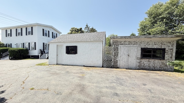 269 County Rd, Lubec, ME 04652 - view of front of property featuring a storage unit and a shingled roof