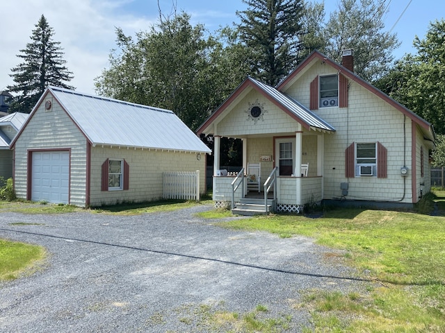 48 Dane Ave, Skowhegan, ME 04976 - view of front facade featuring covered porch, a chimney, driveway, an outbuilding, and a front lawn