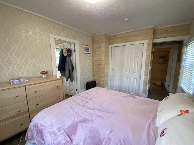 48 Dane Ave, Skowhegan, ME 04976 - bedroom featuring crown molding, a closet, wallpapered walls, and wood walls