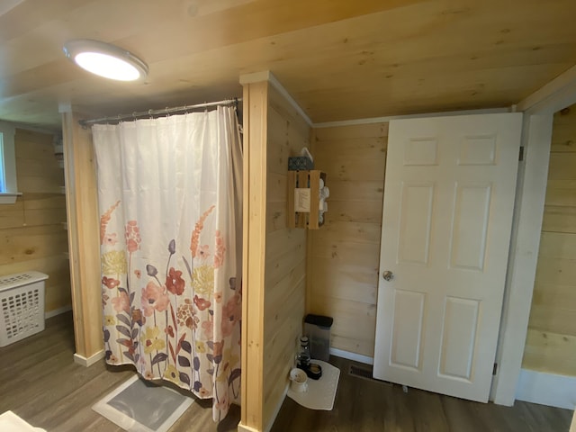 48 Dane Ave, Skowhegan, ME 04976 - bathroom featuring wood finished floors, wood walls, and curtained shower