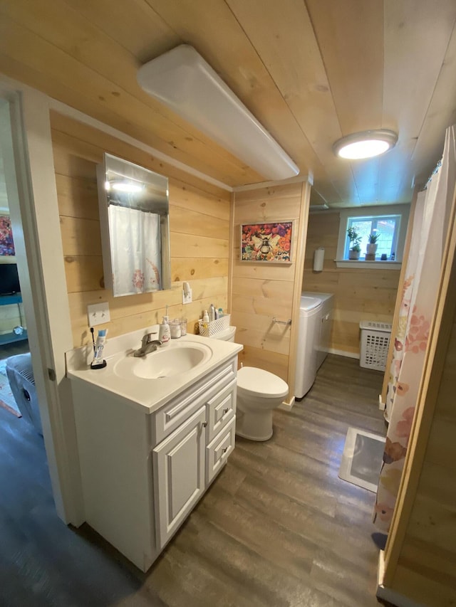48 Dane Ave, Skowhegan, ME 04976 - bathroom with washer and dryer, wood walls, vanity, wood finished floors, and curtained shower